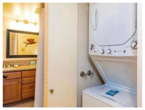 a bathroom with a washing machine and a sink at Live da HI life--great beach and great views! in Wailea