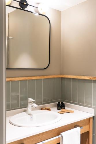 a bathroom with a sink and a mirror at Kapya Cunda in Ayvalık