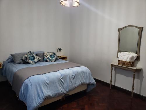 a bedroom with a bed with a mirror on the wall at Arístides Azul in Mendoza