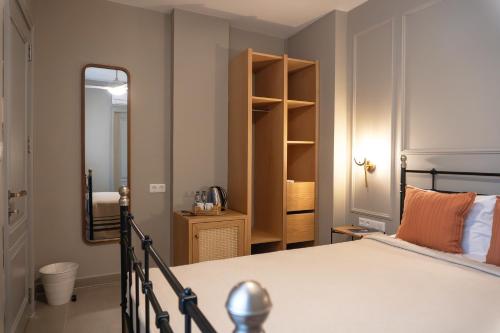 a bedroom with a large bed and a mirror at Kapya Cunda in Ayvalık