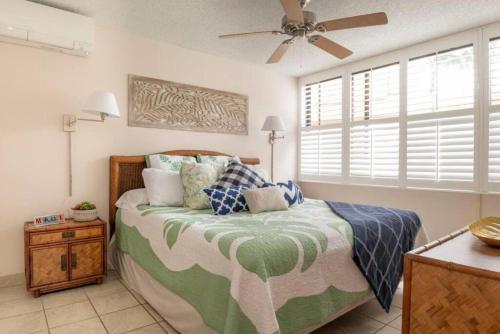 a bedroom with a bed and a ceiling fan at Live da HI life--great beach and great views! in Wailea