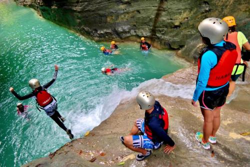 a group of people in the water in a river at The Backyard Inn in Moalboal