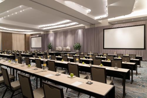 a conference room with tables and chairs and a projection screen at JW Marriott Clearwater Beach Resort & Spa in Clearwater Beach