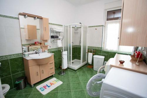 a green bathroom with a shower and a sink at Sea Breeze and beautiful views! in Muros de Nalón