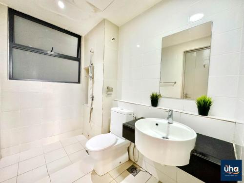 a white bathroom with a toilet and a sink at 1 Tebrau Residences By JK Home in Johor Bahru