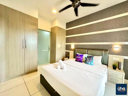 a bedroom with a large bed with a ceiling fan at 1 Tebrau Residences By RR JBcity in Johor Bahru