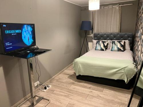 um quarto com uma cama e uma televisão numa mesa em Comfy double room in Corby em Rockingham