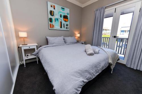 a bedroom with a large bed and a window at River View on Swan in Morpeth