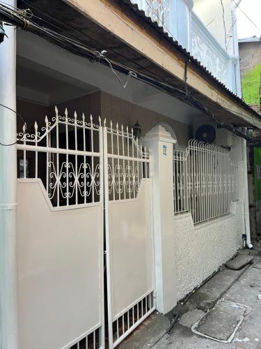 a white gate on the side of a house at RJ Apartment in Catbalogan