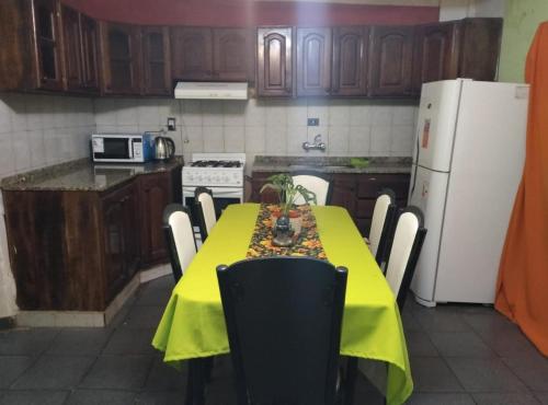 a kitchen with a table with a yellow table cloth on it at Doña Chicha in Tinogasta