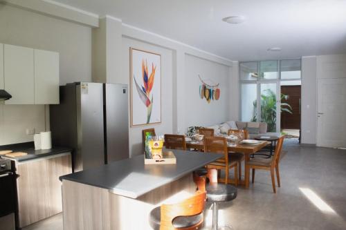 a kitchen and dining room with a table and a refrigerator at Casa Vista verde in Tarapoto