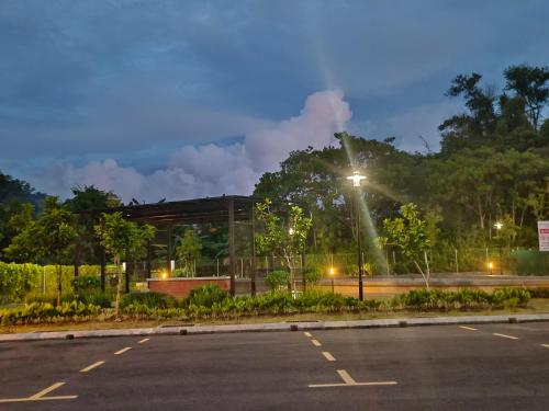 a parking lot in front of a building at night at Nasuha Homestay in Sandakan