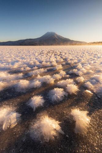a large field of clouds with a mountain in the background at TOTONOU Place in Asahikawa