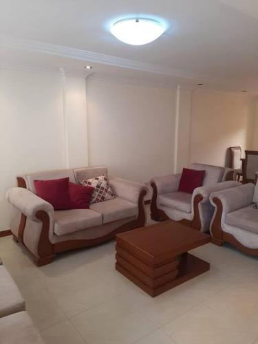 a living room with two couches and a table at Andaluz Townhouse for Rent in Loja