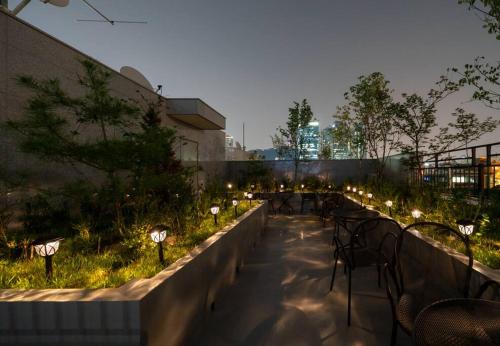 a garden with lights on the side of a building at DanBam House in Seoul