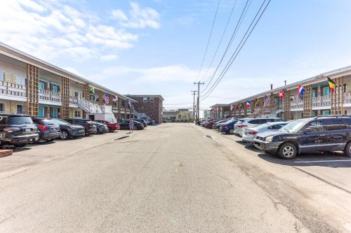 a street with cars parked in a parking lot at The Crest - Hampton Beach in Hampton