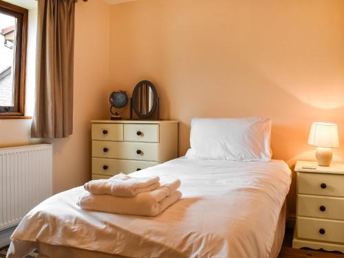 Katil atau katil-katil dalam bilik di Swift Cottage