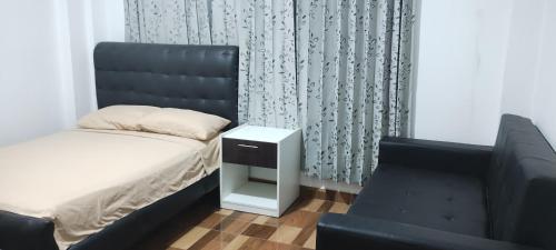 a bedroom with a bed and a chair at Mini depa estreno 4 piso in Puerto Maldonado
