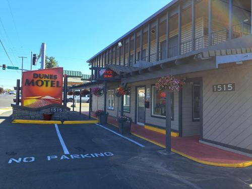 a no parking sign in front of a building at Dunes Motel - Bend in Bend
