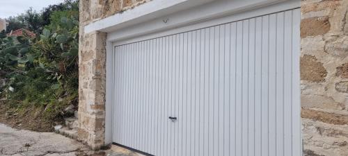 a white garage door on the side of a building at Blue Note House in Asos