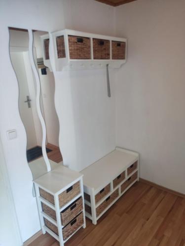 a room with a white desk and cabinets at Ferienwohnung 2 am Hofladen Hellendorf in Bad Gottleuba