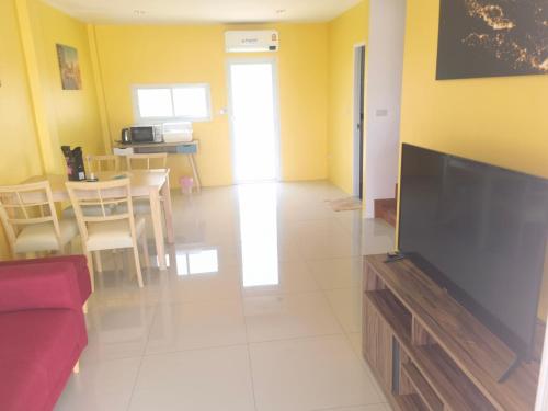 a living room with a large flat screen tv at YYK Homestay in Ban Khlong Krang