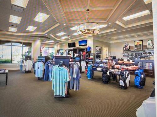 a store with a bunch of shirts on display at GOLF Paradise!-Lakewood National -Beautiful Resort -Palmer's Cove Condo in Bradenton