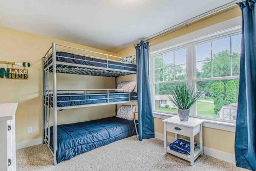 a bedroom with bunk beds and a window at The Heron House-On The Lake! in Wolcottville