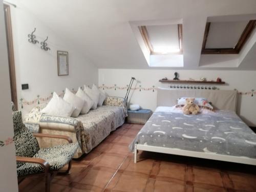 a bedroom with a bed and a couch at La stanza dello Scirocco in Celle Ligure