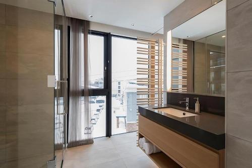 a bathroom with a sink and a large window at Kozue in Niseko