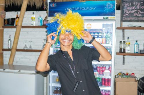 a woman with a wig on her head in a store at Clandestino Hostel Canggu in Canggu