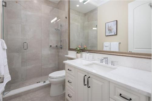 a bathroom with a shower and a toilet and a sink at Vancouver Vacation Home in Richmond
