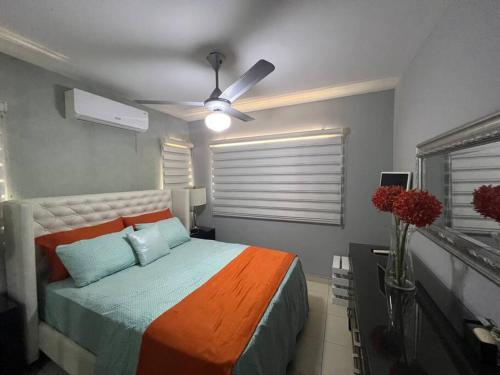 um quarto com uma cama e uma ventoinha de tecto em Apartamento amueblado. em Santiago de los Caballeros