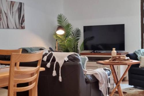 a living room with a couch and a table at Sabi Robe WiFi 300m to Beach Dog friendly in Robe