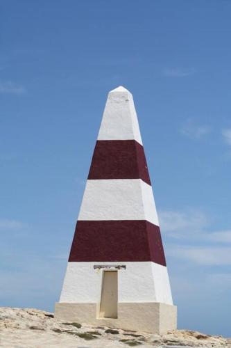 a red and white striped lighthouse in the sand at Sabi Robe WiFi 300m to Beach Dog friendly in Robe