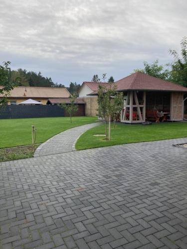 a house with a brick driveway in front of a house at Haus Brandenburg in Stechlin