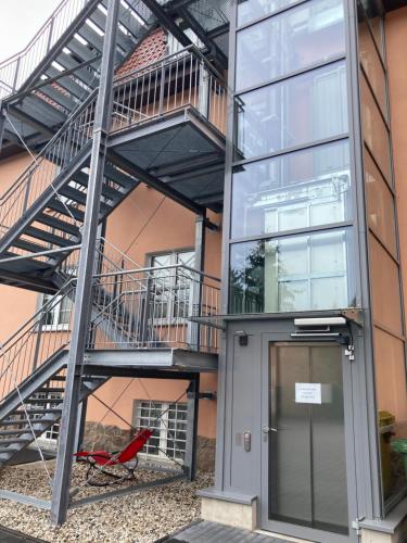 a metal staircase next to a building with a door at Haus Brandenburg in Stechlin