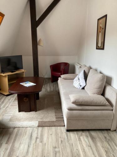 a living room with a couch and a table at Haus Brandenburg in Stechlin