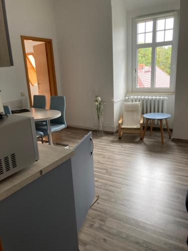 an empty room with tables and chairs and a window at Haus Brandenburg in Stechlin