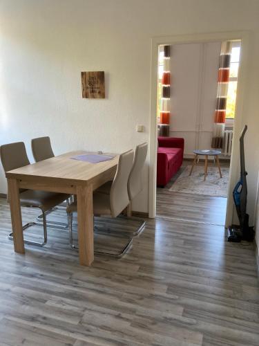 a dining room with a wooden table and chairs at Haus Brandenburg in Stechlin