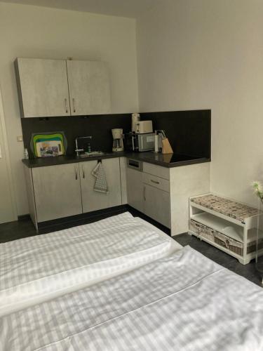 a kitchen with a bed in a room at Haus Brandenburg in Stechlin