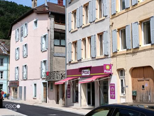 a building with a parking sign on a street at Studio 3 in Moirans-en-Montagne