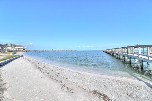 a beach with a pier in the water at Casa de Flip Flops in Rockport