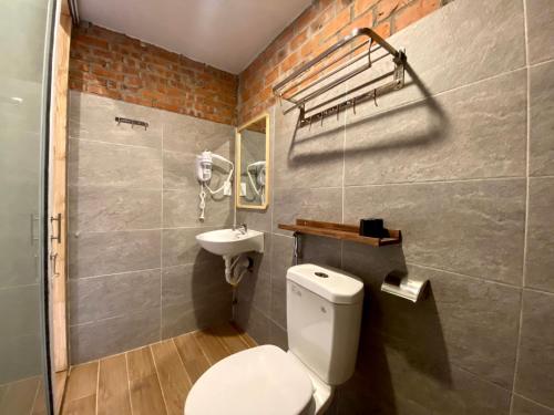 a bathroom with a white toilet and a sink at IKIGAI Dorm Hostel - Danang Beach in Da Nang