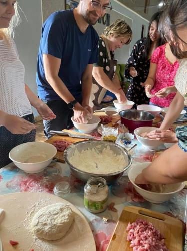 a group of people standing around a table preparing food at Mamuka's Guesthouse in Udabno
