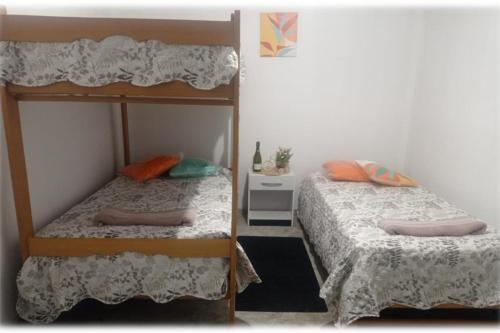 two bunk beds in a small room with at Casa Oliveros in Sunampe