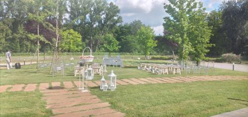 a park with tables and chairs in the grass at La Rondanina in Castelnuovo Fogliani