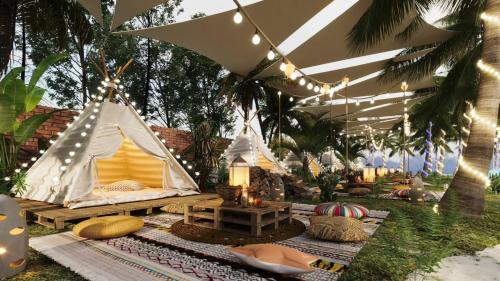 a marquee with a tent and a table and lights at Muine Sun & Sea Resort in Mui Ne