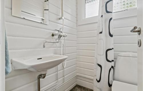a white bathroom with a sink and a toilet at Beach Front Home In Rnne With Wifi in Rønne