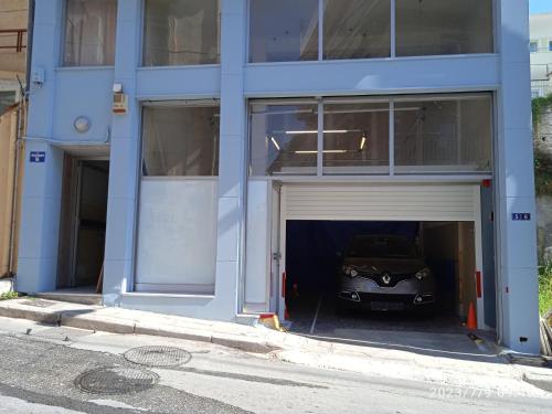 a car is parked inside of a garage at Central Home Kavala "private parking" in Kavala